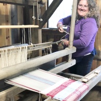 Amber at Mill Creek's ancient loom--It works, but sometimes it takes a little ingenuity!